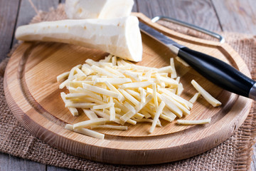 Chopping parsnip on wooden board