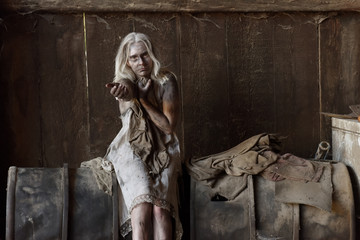 A scene of a young woman in poverty. The young woman is seen to be situated in a poor unclean...