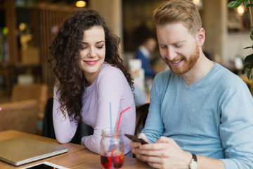 Young couple having date in coffee shop