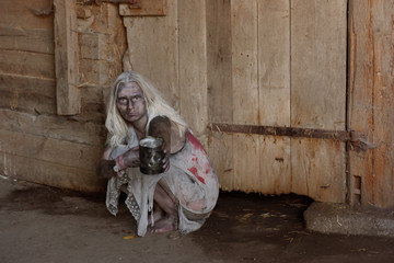 A scene of a young woman in poverty. The young woman is seen to be situated in a poor unclean...