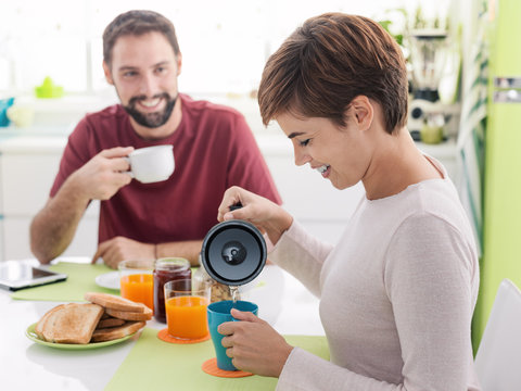Young loving couple having breakfast at home
