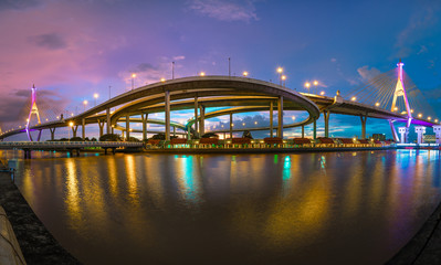 Naklejka na ściany i meble Panoramic view of Bhumibol Bridge, the Industrial Ring Road Bridge in the night scene after sunset. Twilight sky and light reflection on smooth water, Thailand