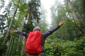 Photo from back of woman with arms raised