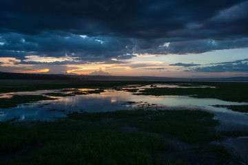 Fototapeta na wymiar Gloomy sunset along the swampy area of Nakuru Lake