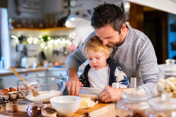 Young family making cookies at home.