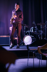 Fototapeta na wymiar Saxophone player performing on stage