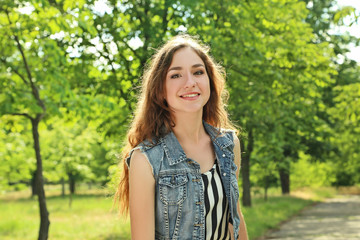Fototapeta premium Portrait of young woman in the park