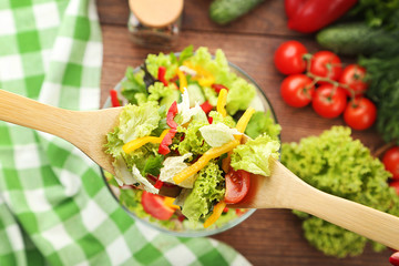 Fresh vegetable salad in wooden spoons