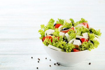 Vegetable salad in bowl on wooden table