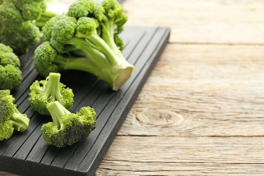 Fresh broccoli on black cutting board