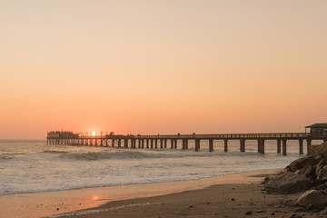 Silhouette of the historic jetty against setting sun in Swakopmund