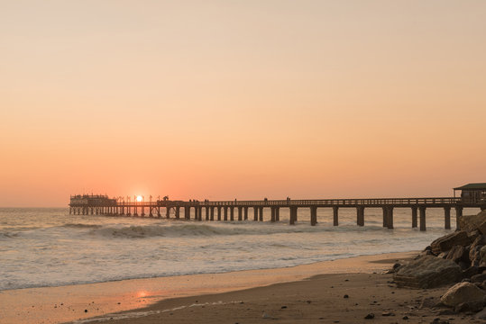Silhouette of the historic jetty against setting sun in Swakopmund