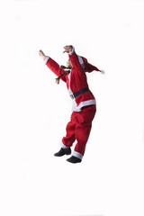 Little caucasian girl dressed as Santa Claus jumping on white background.