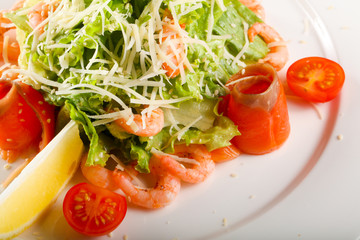 Caesar salad with shrimps and salmon