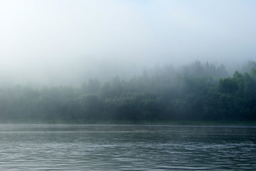 Morning mist over the Ural river Vishera. View across the river to the opposite shore, lost in the fog