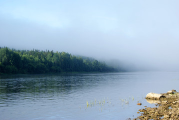 morning mist over the Ural river Vishera, view from the shore. the shore in the background is lost in the haze..
