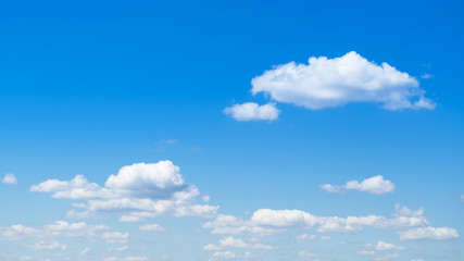 Naklejka na ściany i meble Wide clear blue sky with fluffy clouds