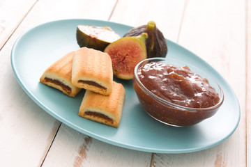 Sweet fig jam smeared on a toast on white wooden table
