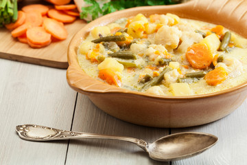 Vegetable soup with ingredients carrot, cauliflower, potato and