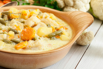 Vegetable soup with ingredients carrot, cauliflower, potato and