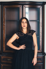 Fototapeta premium Young pretty girl posing in a beautiful room with wooden furniture