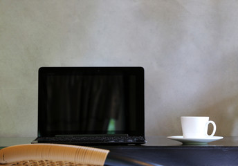Laptop On the desk In office at home style loft cement wall in background
