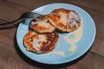 Appetizing sour cream with cream on a blue plate on a wooden dark background