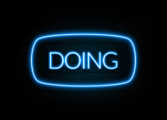 Doing  - colorful Neon Sign on brickwall