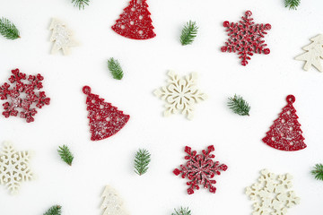 Christmas card. Christmas fir branch, Christmas decorations in the form of a Christmas tree, snowflakes in the snow on a white background