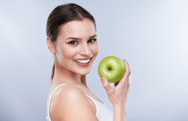 Smiling woman with green apple