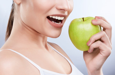 White smile and green apple