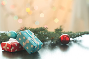 Christmas gifts or New Year with decorations on table on bokeh background