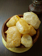 Brown Prawn Crackers Oriental fried prawn crisps, (made from goat or cow skin), at Wooden Small Bowl
