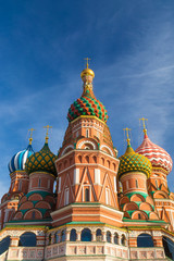 Fototapeta na wymiar The most famous architectural place for visiting and attraction in Moscow, Russia, Saint Basil's cathedral with colorful cupolas and spectacular domes in traditional culture on cloudy blue sky