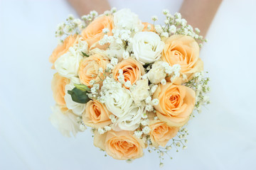 Bouquet with flowers in the hands of the bride