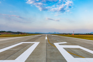 Runway, airstrip in the airport terminal with marking on blue sky with clouds background. Travel aviation concept. - 177130952