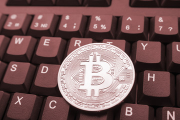golden bitcoin on keyboard