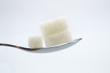Pieces of white sugar on a stainless