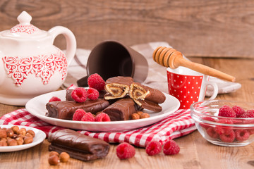Fototapeta premium Chocolate rolls with hazelnuts and raspberries.