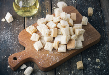 homemade croutons from white bread in wood on old wood table