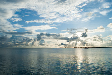 Obraz premium post sunset the caribbean sky is full of clouds. The epic scene reflects off the calm ocean