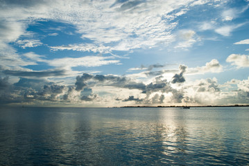 Obraz premium post sunset the caribbean sky is full of clouds. The epic scene reflects off the calm ocean