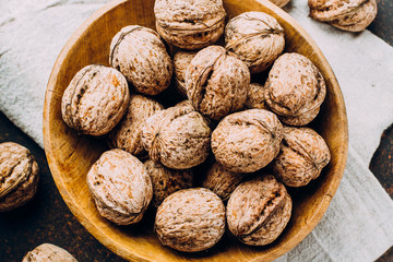 Whole walnuts on dark stone concrete table background. Copy space. Healhty Vegetarian Vegan Food Concept
