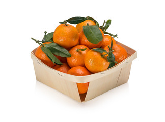 Basket of  freshly picked tangerines with leaves isolated on white background - obrazy, fototapety, plakaty