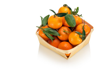 Basket of  freshly picked tangerines with leaves isolated on white background - obrazy, fototapety, plakaty