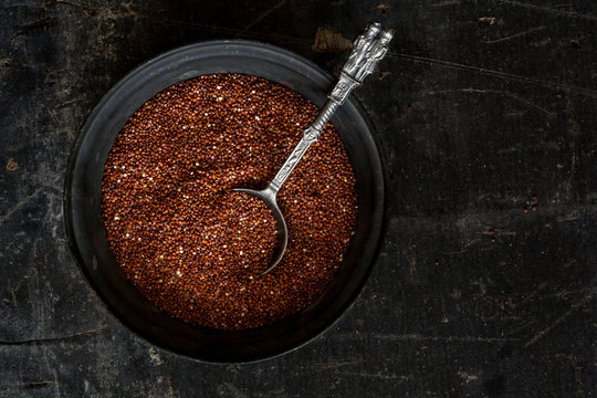 Red raw quinoa in a rustic bowl