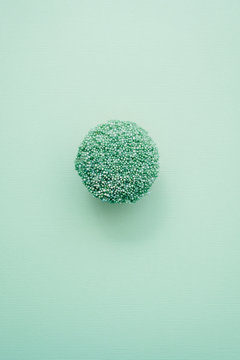 Cupcake With Green Sprinkles On A Pastel Green Background