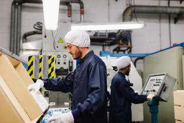 Two co-workers working in a factory.