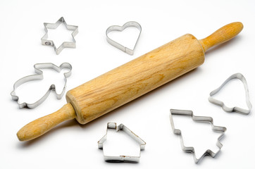 rolling pin with cookie cutters on a white background