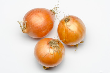 three onions on a white background